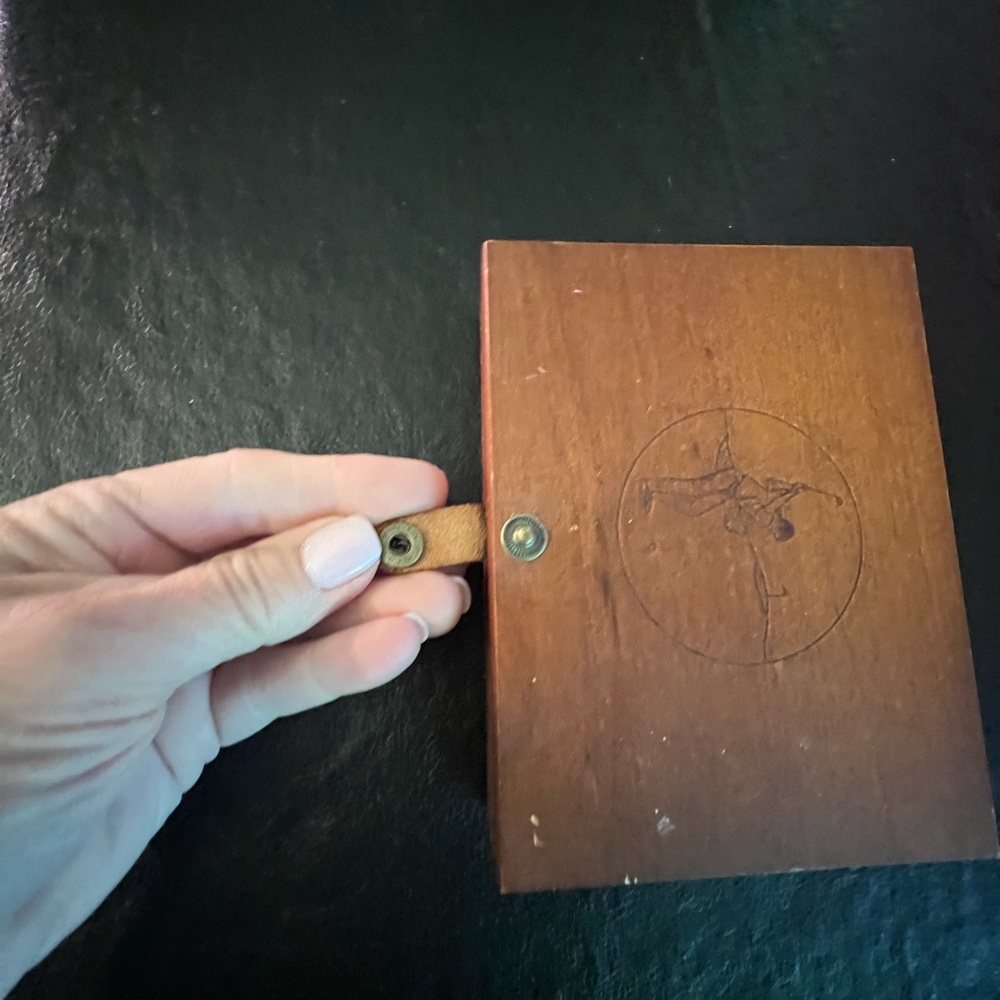 Wooden box with playing cards and golfer on them. Golfer etched in cover of box